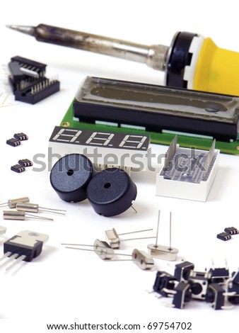 Electronic components and soldering iron isolated on white background