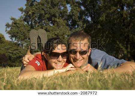 Happy couple relaxing in the park in summer
