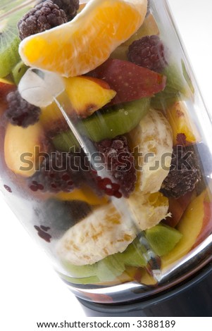 glass blender filled with a selection of healthy fruits and ice ready to make a smoothie