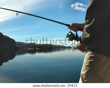 Boy fishing by the ocean