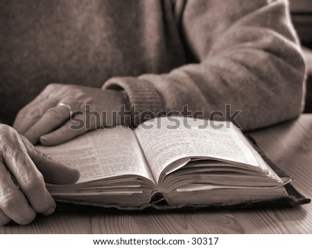 Elderly womans hands and Bible