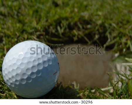 Golfball on the edge of the hole