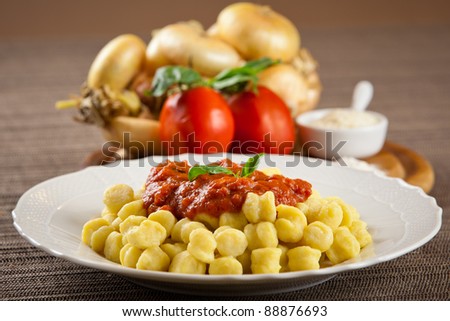 Cooked plate of homemade pasta with ingredients. Tomato, onion, flour, parmesan cheese