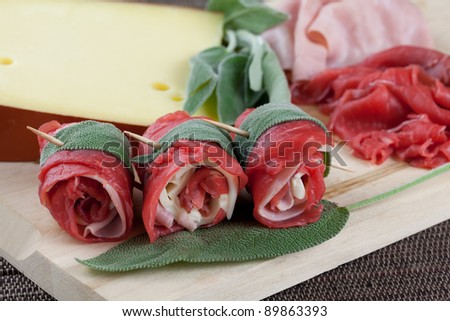 beef wraps with cheese, ham and sage ready to be cooked