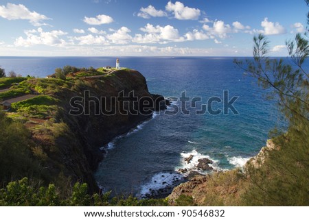 Kilauea lighthouse northern guide in Kauai island and underlying cove with calm ocean in background