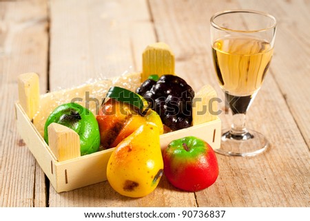 wood box of sweet traditional marzipan fruit and glass of dessert wine