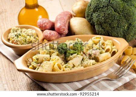 Traditional Italian macaroni pasta with broccoli, potatoes and sausage. Served in a terrine and surrounded by raw ingredients