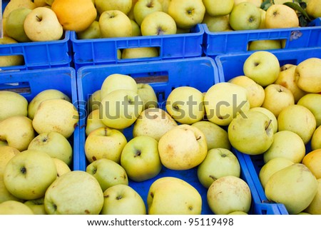 Box of fresh apples at market booth