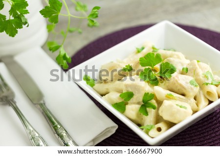 Chicken Aldredo garnished with flat leaf parsley, horizontal