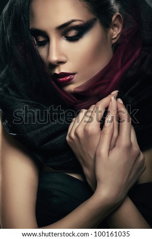 woman in black hood with closed eyes