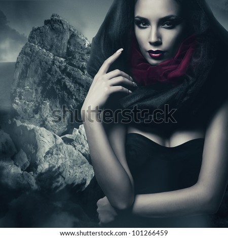 sexy woman in black hood and rock