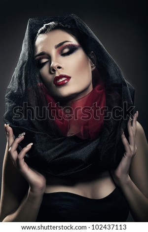 mysterious woman with closed eyes in black hood