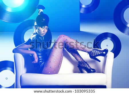 stock photo : Attractive african woman siting in white chair on vinyl