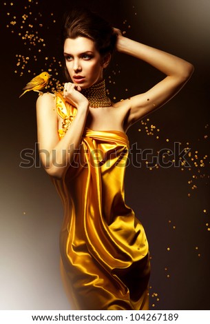 attractive woman in yellow dress with bird