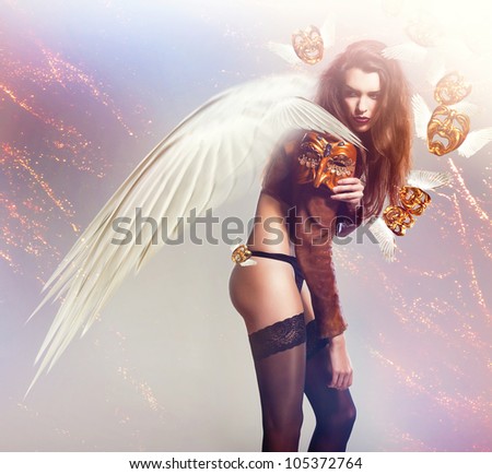 beautiful sexy woman with wings and flying masks