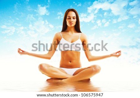 attractive brunette woman in yoga poseattractive brunette woman in yoga pose and sky