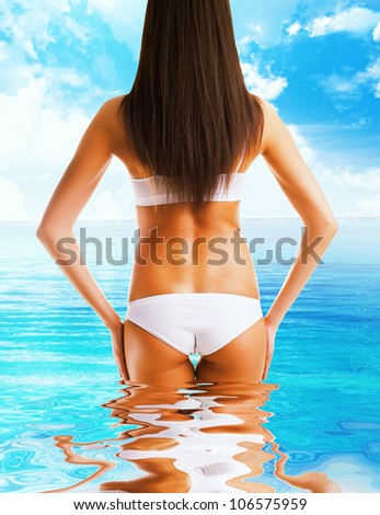 slim healthy woman body in the sea water