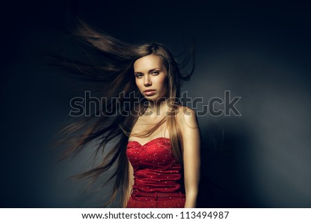 pretty woman in red with long windy hair