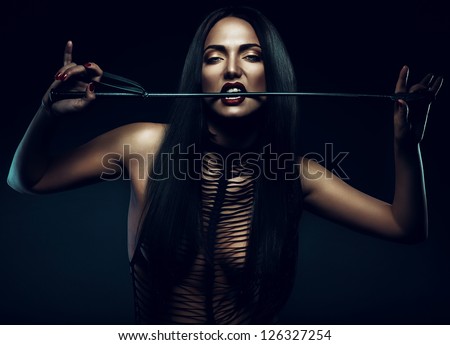 woman with red lips biting whip
