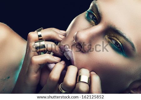 woman with fingers on lips