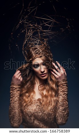 pretty woman with gold accessory on head