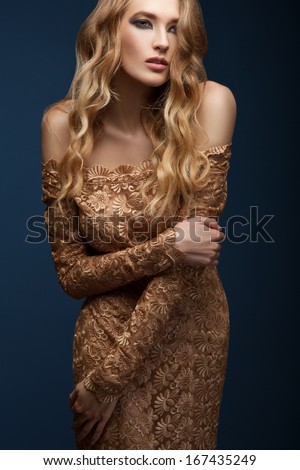 Half-length shot of a beautiful woman in golden dress