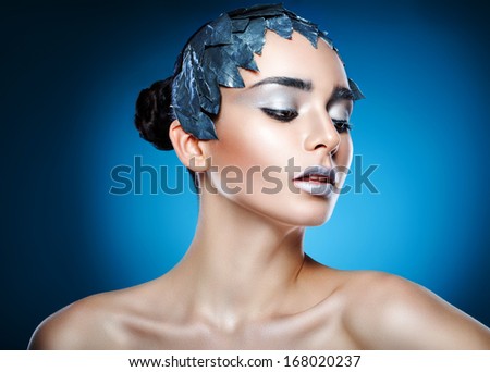 cold woman in accessory of silver leaves