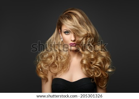 Portrait of a woman with curly hair on a gray background Portrait of a woman with curly hair on a gray background