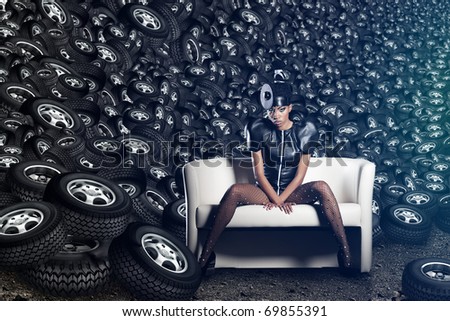 Attractive woman siting in chair on tires