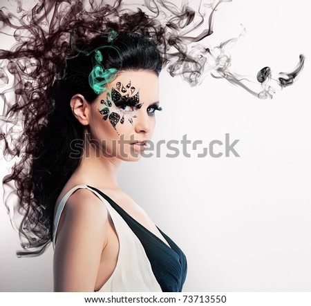 stock photo face art of rhinestones on brunette woman and smoke