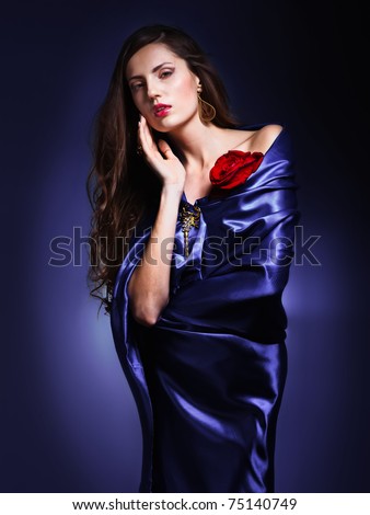 portrait of a beautiful woman in violet dress whith rose