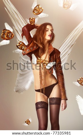 attractive woman with wings and flying venetian masks