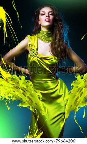 sensual beautiful woman in green dress and paint splash