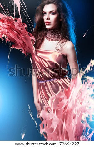 slim sexy woman in pink dress with long hair and paint splash