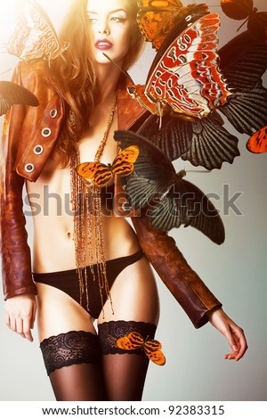 beautiful woman with butterflies on shoulder