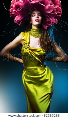 sensual beautiful woman in green dress and flower hat