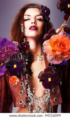 stock photo erotic woman with silver accessory in flowers