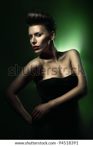 pretty beautiful woman with red lips in dark green light