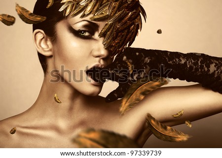 woman with black glove and gold feather