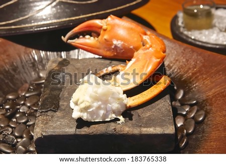 Steamed Crab leg on hot stone plate.