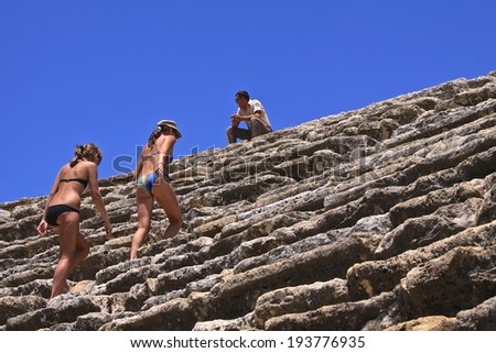 PAMUKKALE, TURKEY - JULY 1:Tourists visit ancient Greco-Roman and Byzantine city of Hierapolis that build on top of Pamukkale when they finished spa in antique hot spring pool,July 1, 2009, Turkey.