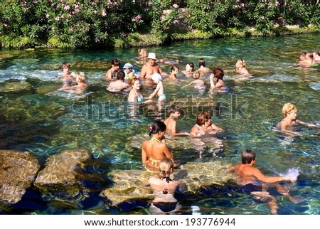 PAMUKKALE, TURKEY - JULY 1:People enjoy hot spring spa in antique pool at Pamukkale,July 1, 2009. pamukkale, meaning 
