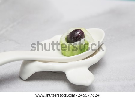 Steamed Vegetable sponge topping Ginger Lily and dates fruit on spoon for one bite.