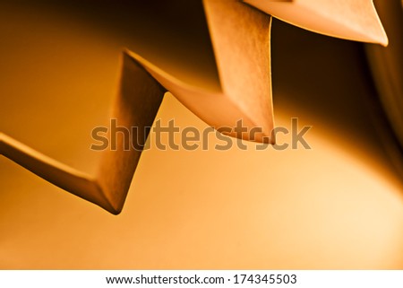 Macro, abstract, background picture of a  orange zig-zag paper on paper background
