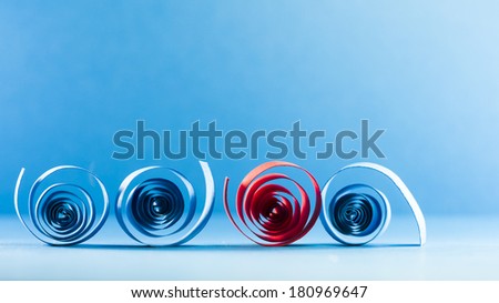 Macro, abstract, background picture of blue and red paper spirals on paper background