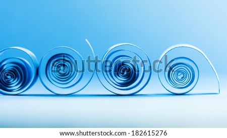 Macro, abstract, background picture of blue paper spirals on paper background
