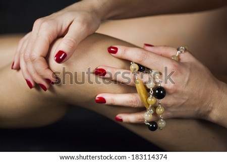 Woman hands with jewels on her knee