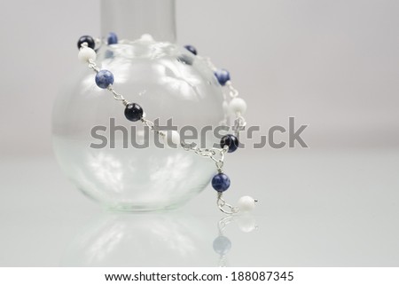 Silver bracelet with with lapis lazuli, jade and sodalite gemstones on white background