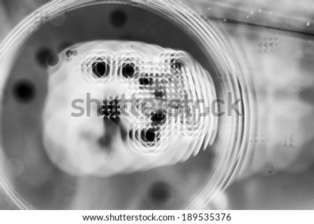 Abstract, blurred, black and white composition with oil, water and ink