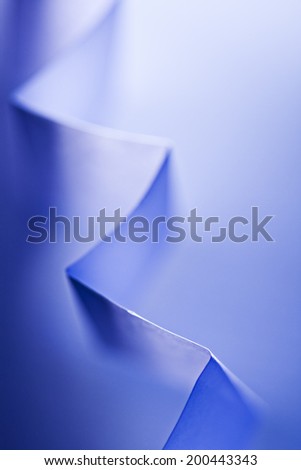 Macro, abstract, background picture of a blue zig-zag paper on paper background